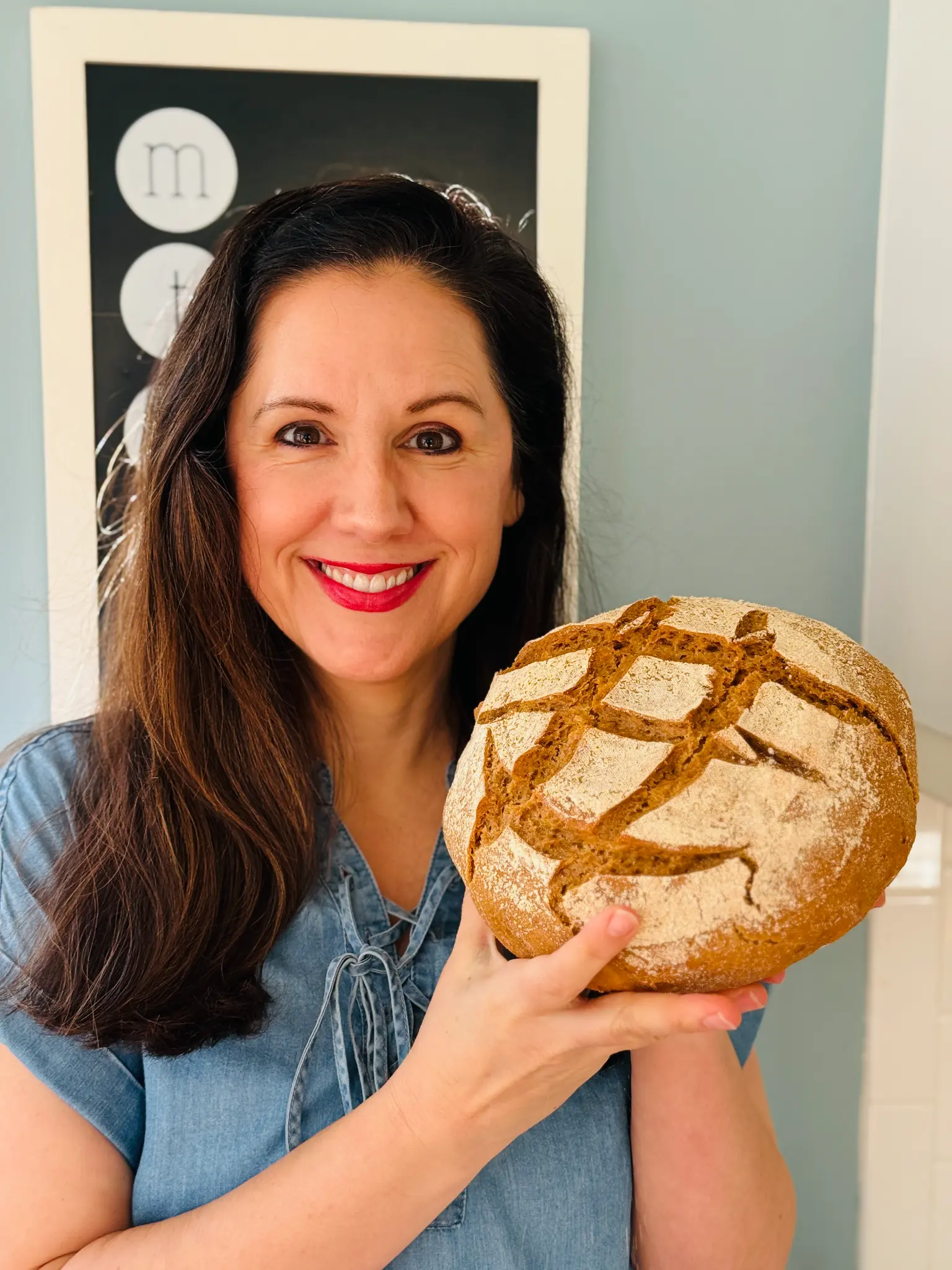 Ashley from Fresh Flour Living holding fresh sourdough bread