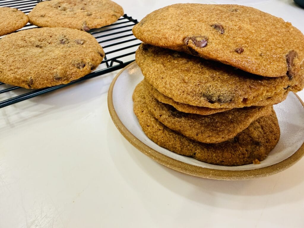 Fresh milled einkorn chocolate chip cookies stacked on a plate with Fresh Flour Living