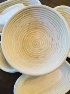 Empty round banneton basket showing the spiral rattan weave before proofing dough